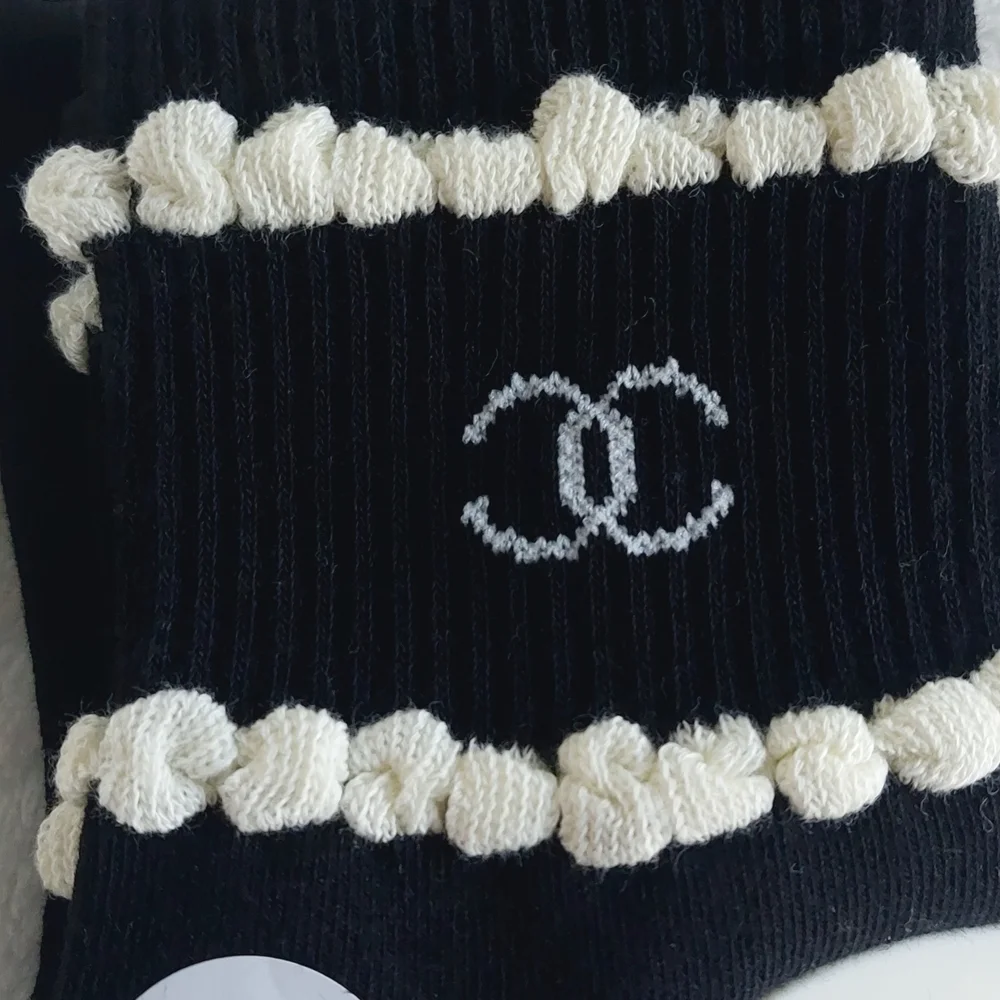 2 Pair of socks. 1 Cream trimmed in Black, 1 Black trimmed In Cream Women Size 7